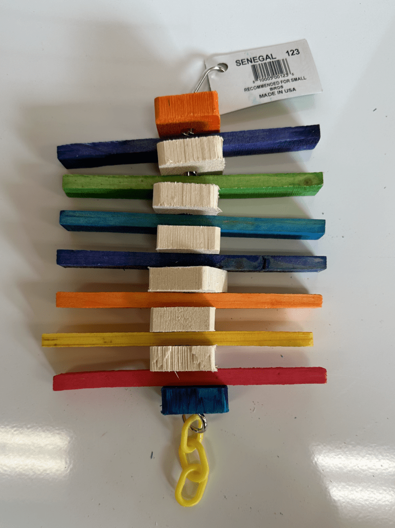 A colorful Senegal Toy hanging from a string.